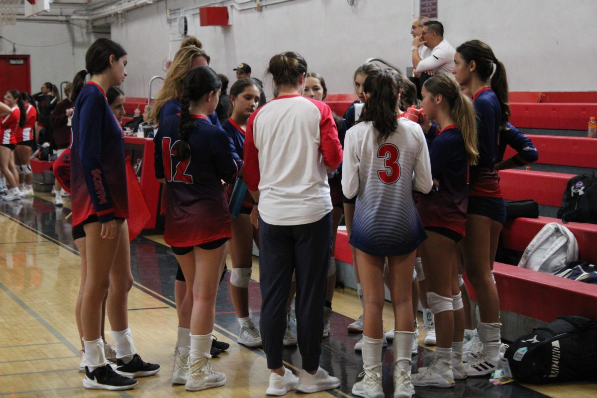 The MAST Academy junior varsity girls volleyball team huddles up after its loss to host Coral Gables Senior High School on Sept. 14, 2023.