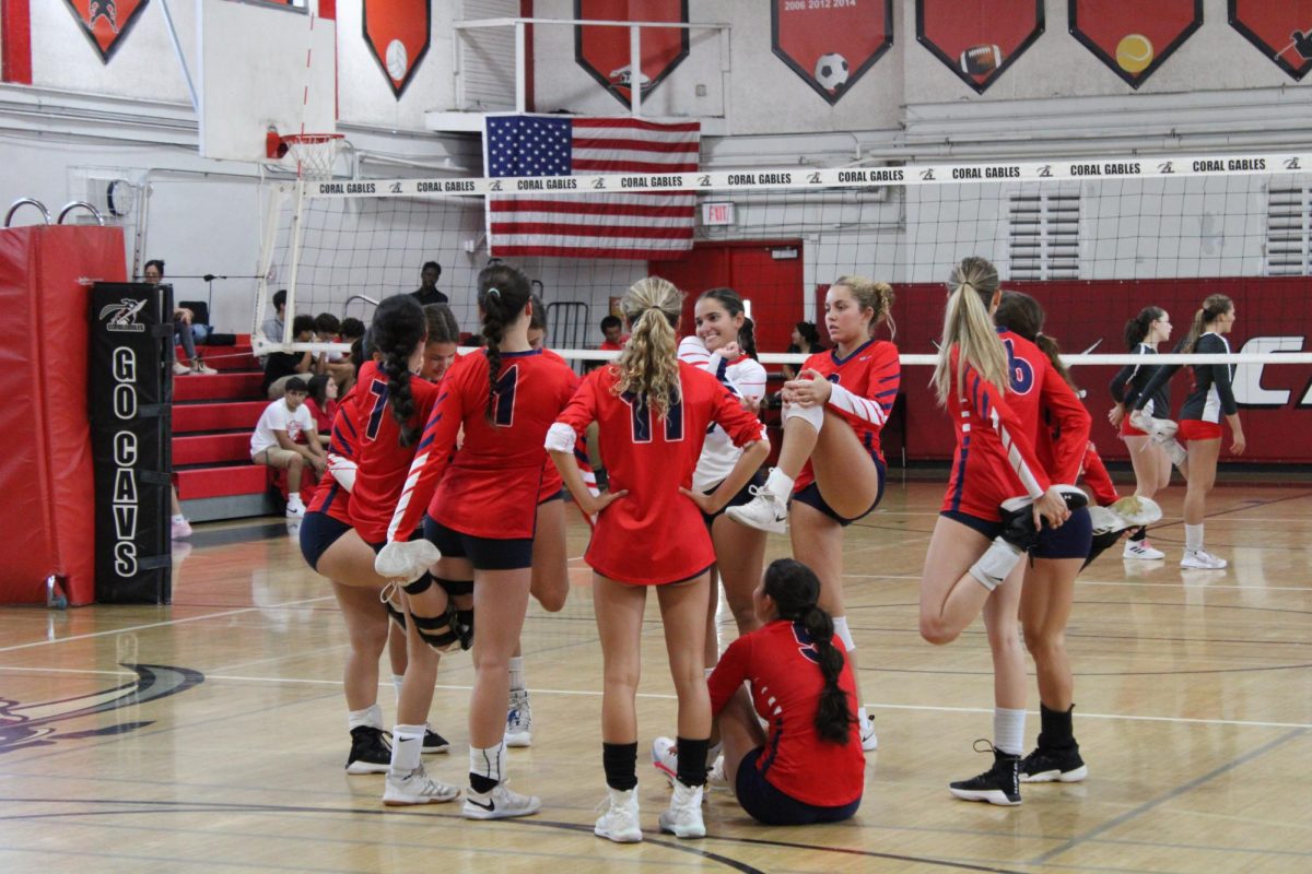 The MAST Academy varsity girls volleyball team stretches before its match against host Coral Gables Senior High School on Sept. 14, 2023.