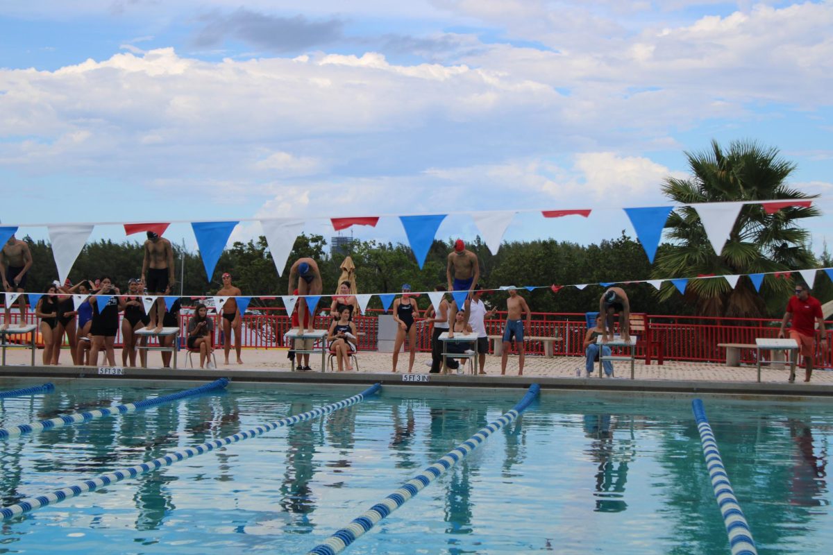 The MAST Academy Boys Swim Team preparing for a race at the MAST Academy pool.