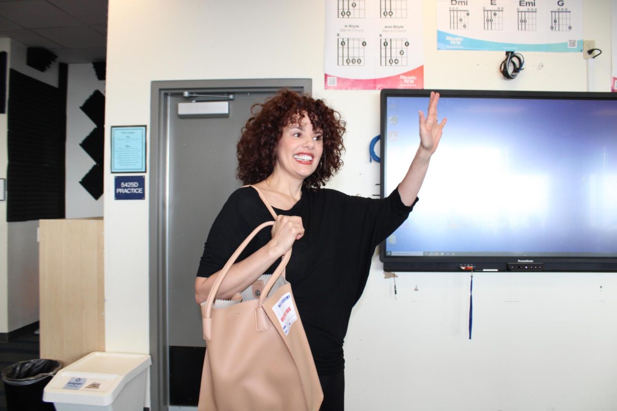 Broadway actress Janet Dacal waves to students as she enters Mr. Gomezs room to speak to MAST Academy students.
