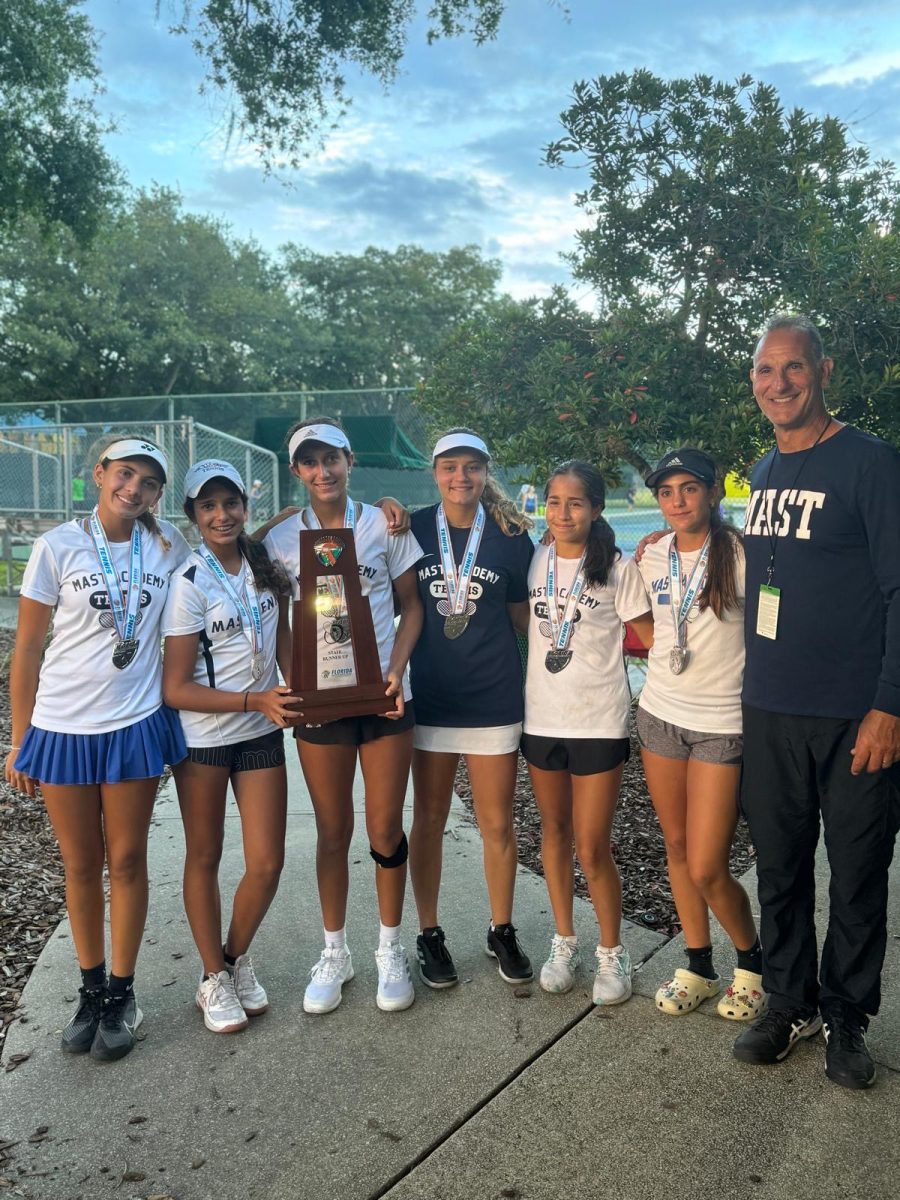 Members of the MAST Academy girls tennis team and Coach Kontos pose with their state runner-up trophy at Red Bug Lake Park in Casselberry, Florida on April 30, 2024. Photo courtesy Coach Kontos.